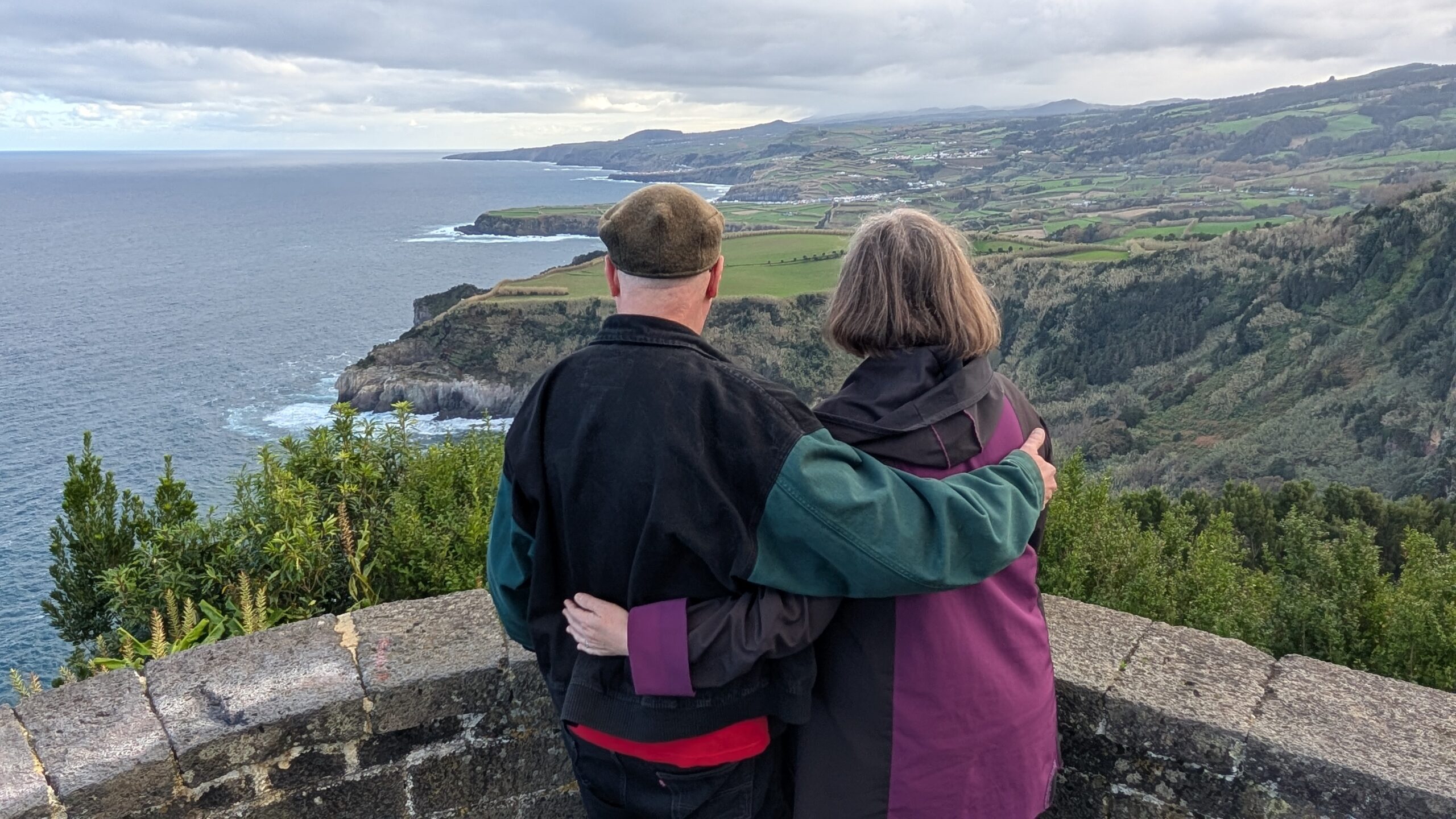 The author and their spouse looking over a scenic coastline vista.
